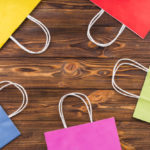 arrangement colorful paper shopping bag wooden background 23 2148101622